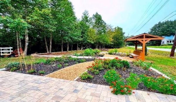 Patio flowers and covered bench. 