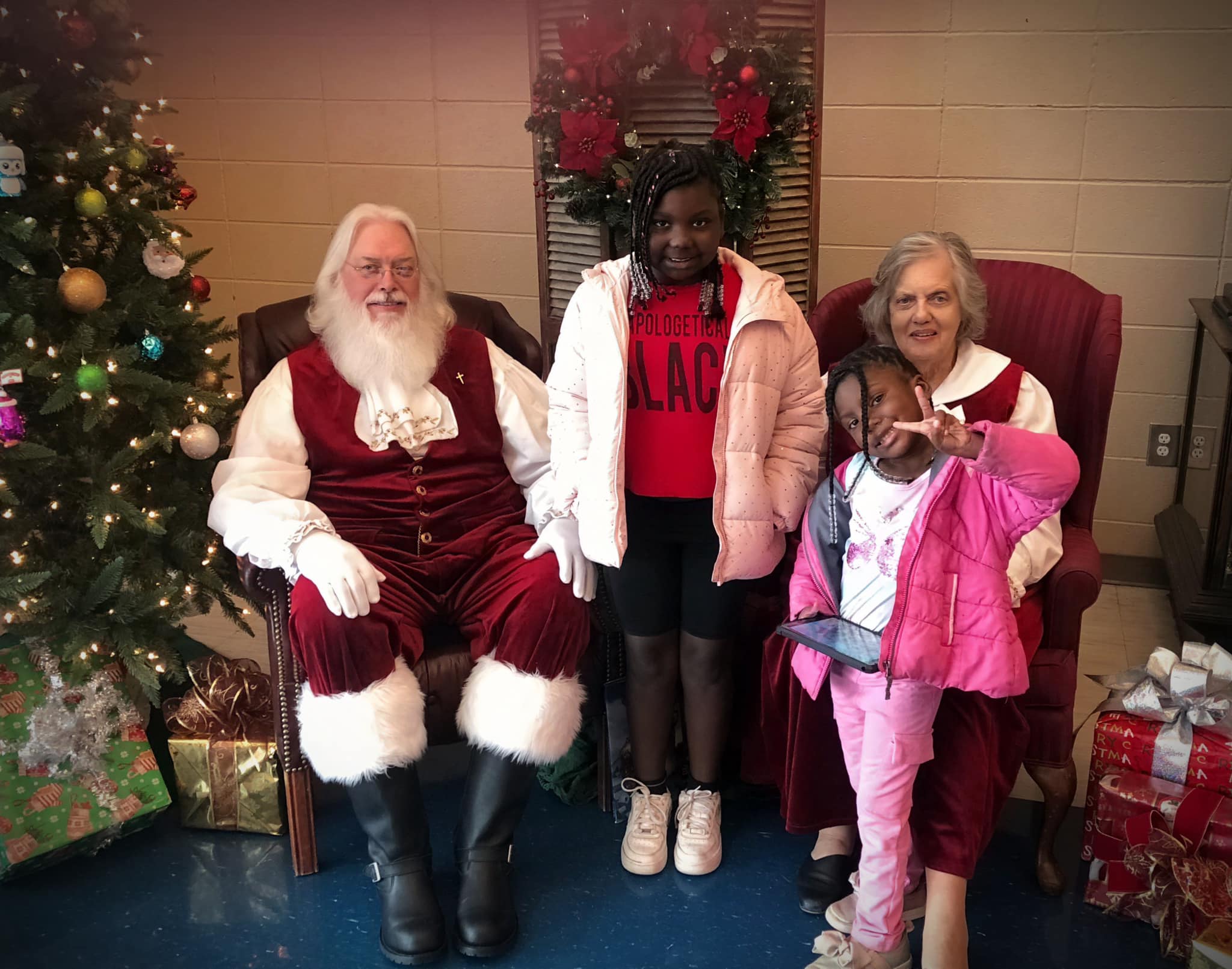 Mr. and Mrs. Santa with two children.