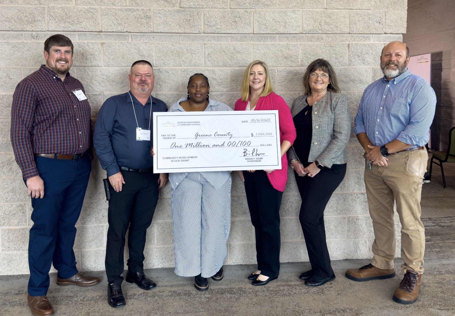 Six People Holding a Large Check